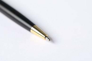 Photo of One stylish pen on light background, macro view. Space for text