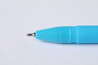Photo of One stylish pen on light background, macro view. Space for text
