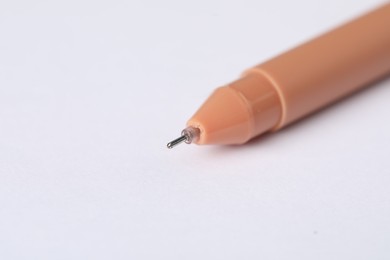 Photo of One stylish pen on light background, macro view. Space for text