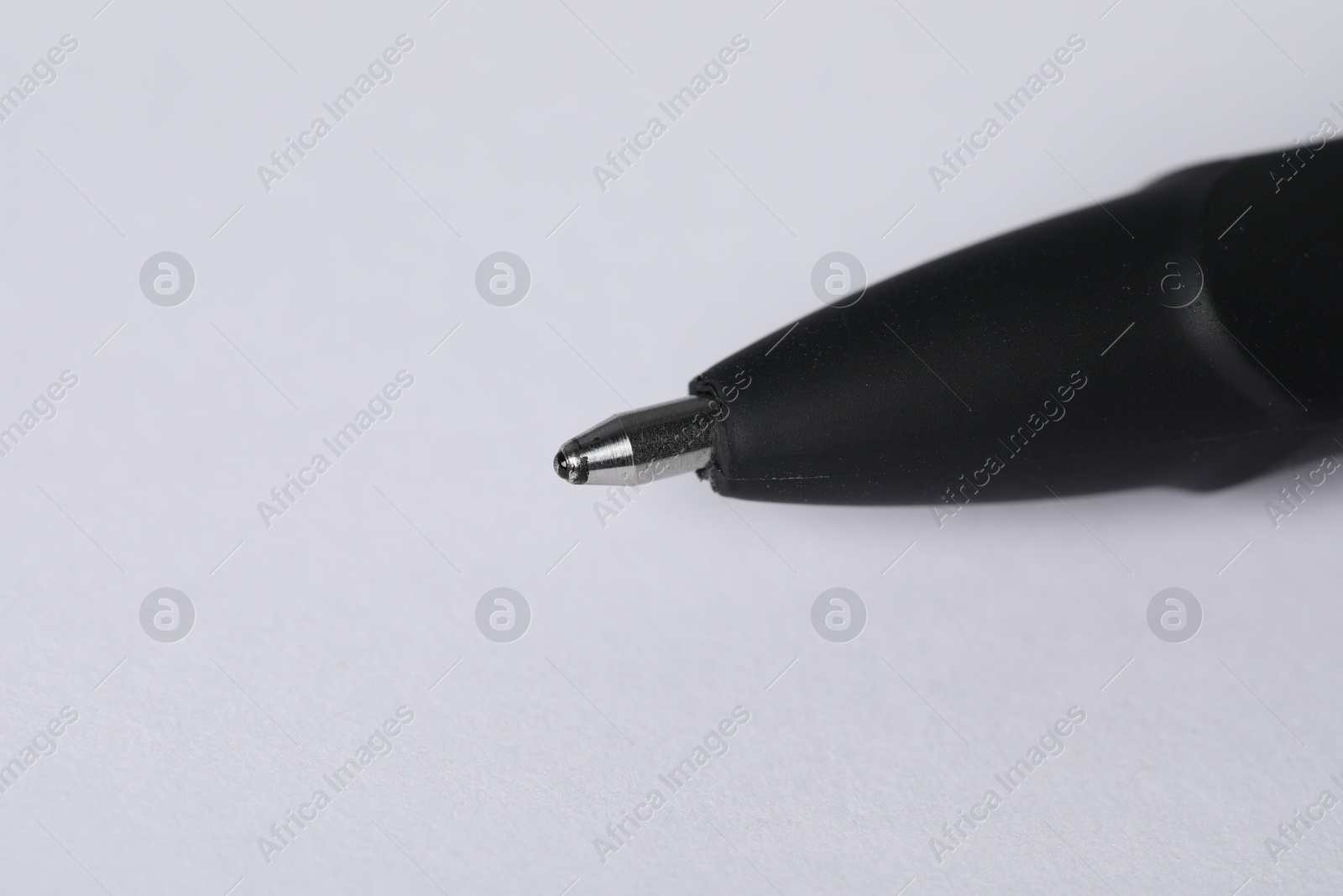 One stylish pen on light background, macro view. Space for text Photo of One stylish pen on light background, macro view. Space for text