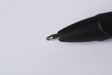 Photo of One stylish pen on light background, macro view. Space for text