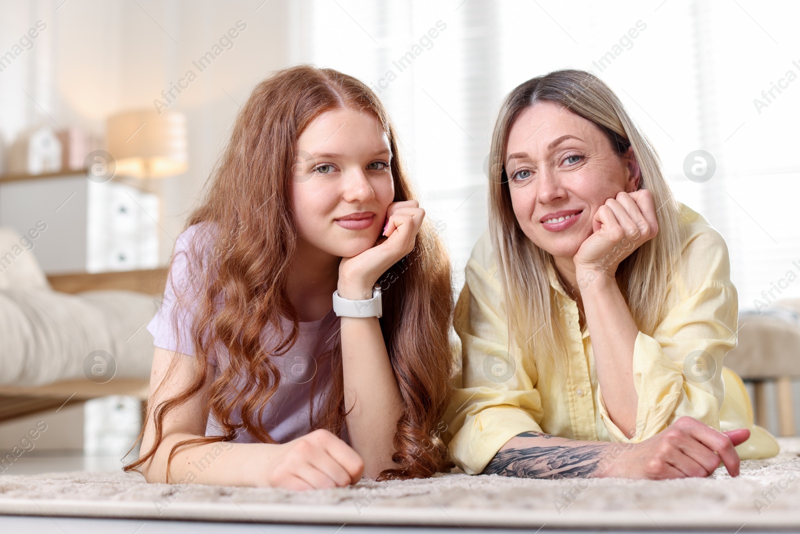 Mother and her daughter on floor at home Photo of Mother and her daughter on floor at home