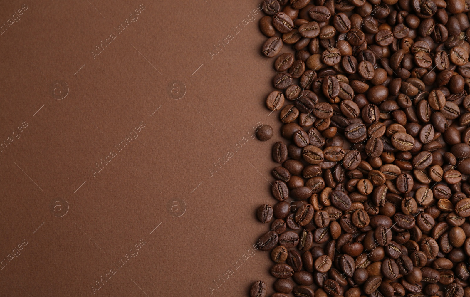 Aromatic coffee beans on brown background, top view. Space for text Photo of Aromatic coffee beans on brown background, top view. Space for text