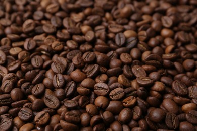 Photo of Pile of aromatic coffee beans as background, closeup