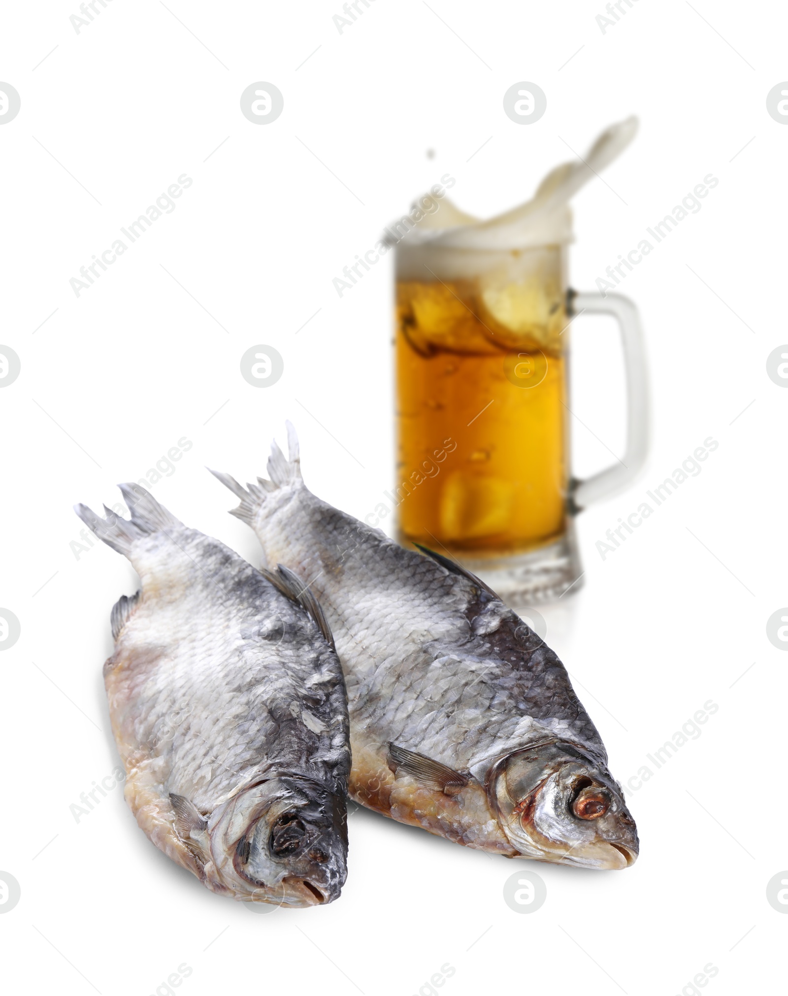 Beer splashing out of glass and dried fish on white background Image of Beer splashing out of glass and dried fish on white background