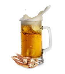Image of Beer splashing out of glass mug and dried fish isolated on white
