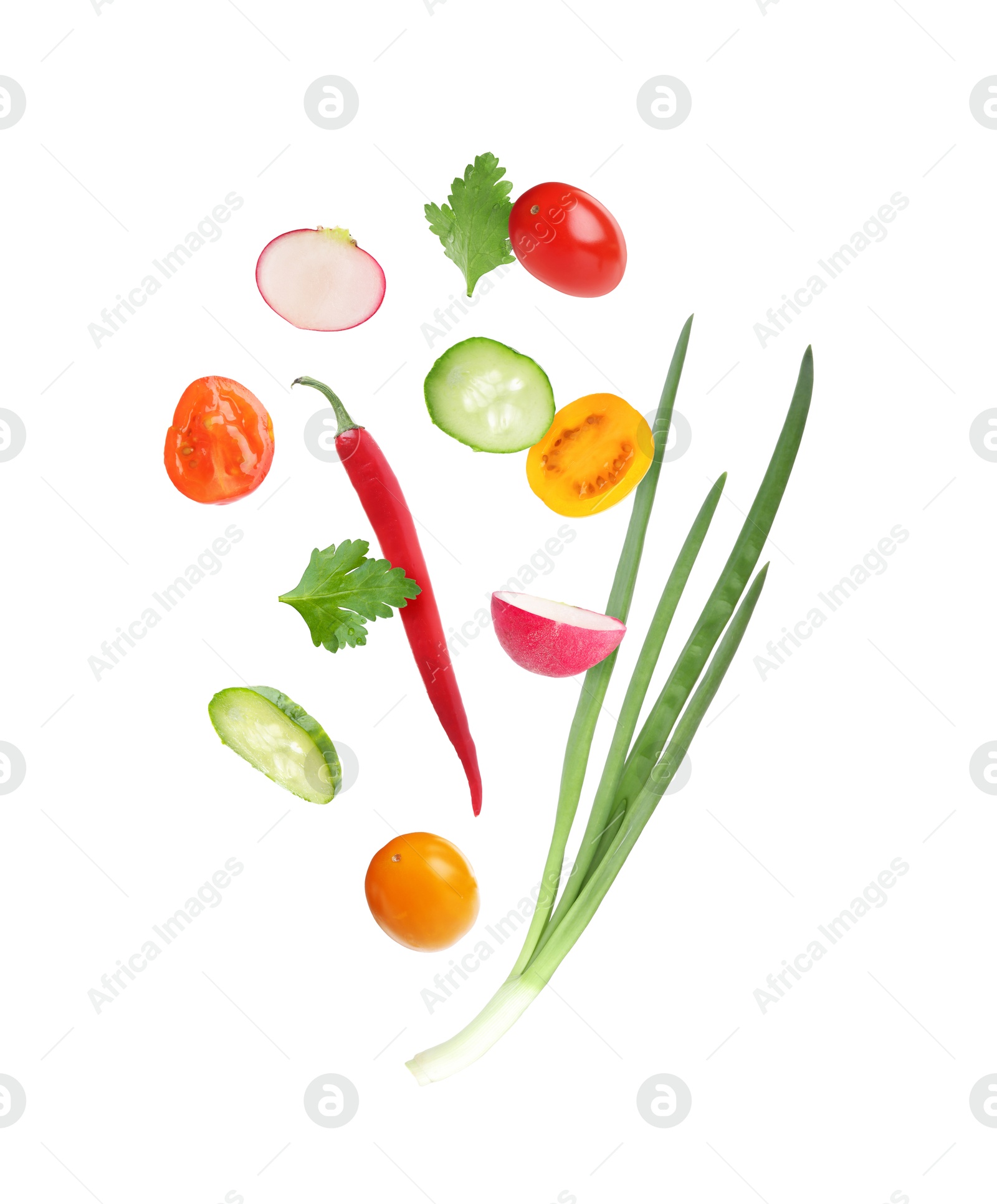 Different cut fresh vegetables falling on white background Image of Different cut fresh vegetables falling on white background