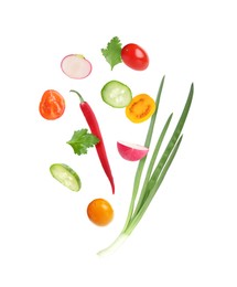 Image of Different cut fresh vegetables falling on white background