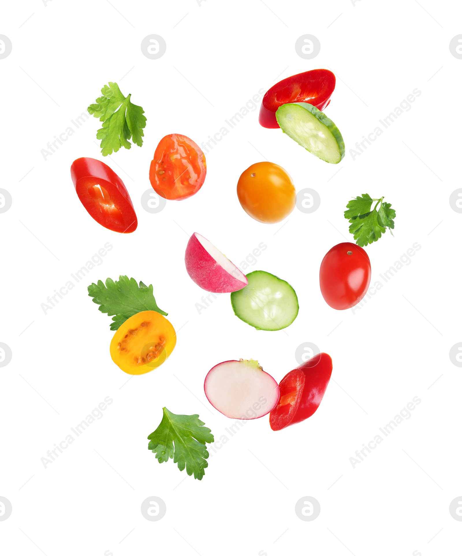 Different cut fresh vegetables falling on white background Image of Different cut fresh vegetables falling on white background