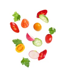 Image of Different cut fresh vegetables falling on white background