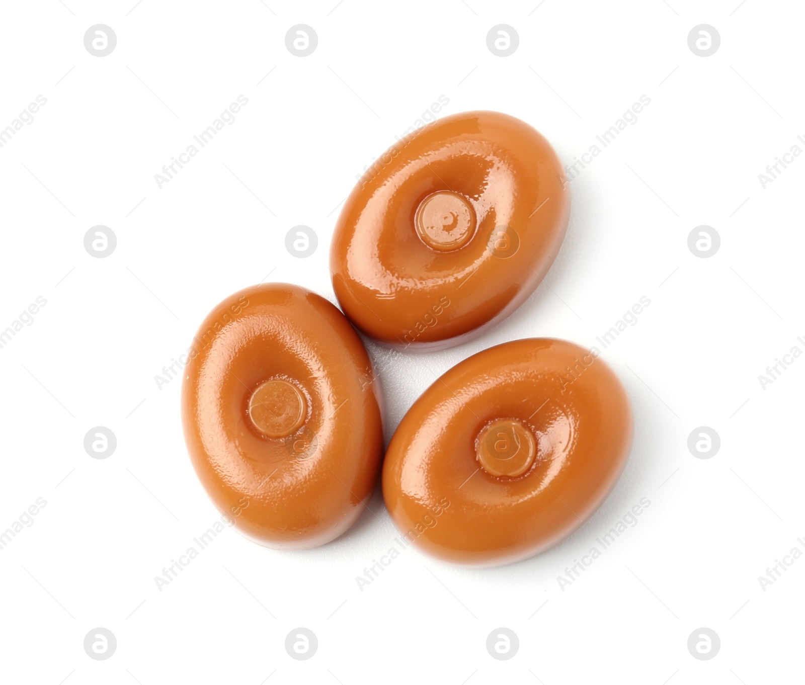 Tasty hard toffee candies isolated on white, top view Photo of Tasty hard toffee candies isolated on white, top view