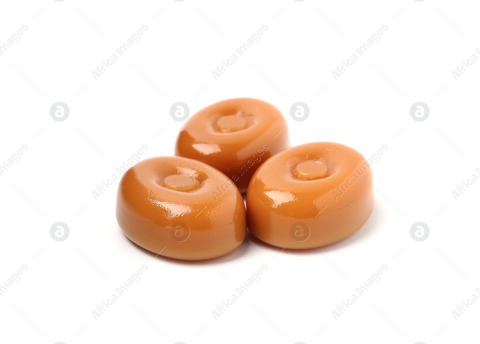 Tasty hard toffee candies isolated on white Photo of Tasty hard toffee candies isolated on white