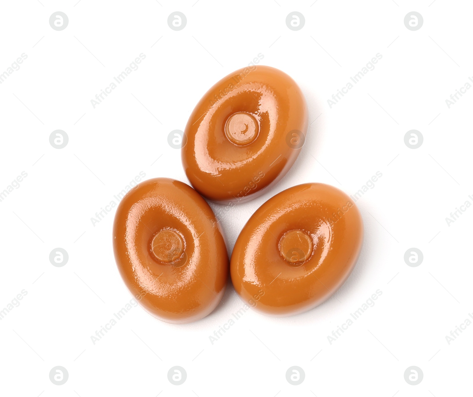 Tasty hard toffee candies isolated on white, top view Photo of Tasty hard toffee candies isolated on white, top view
