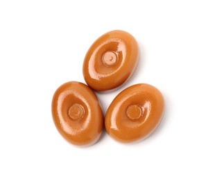 Photo of Tasty hard toffee candies isolated on white, top view