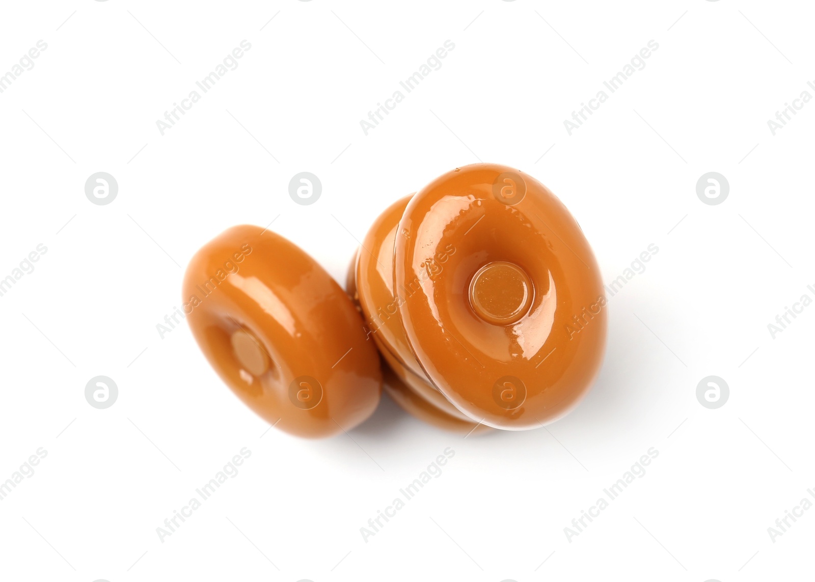 Tasty hard toffee candies isolated on white, top view Photo of Tasty hard toffee candies isolated on white, top view