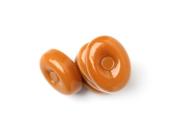 Photo of Tasty hard toffee candies isolated on white, top view