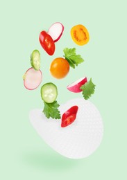 Image of Rice paper and different ingredients falling on aquamarine color background
