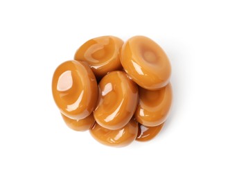 Photo of Tasty sweet caramel candies isolated on white, top view