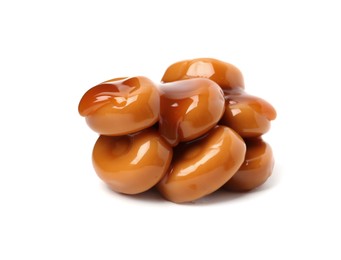 Photo of Tasty sweet candies and caramel sauce isolated on white