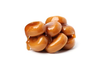 Photo of Tasty sweet candies and caramel sauce isolated on white