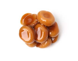 Photo of Tasty sweet candies and caramel sauce isolated on white, top view