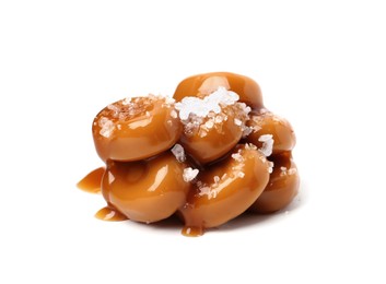 Photo of Tasty sweet candies, salt and caramel sauce isolated on white