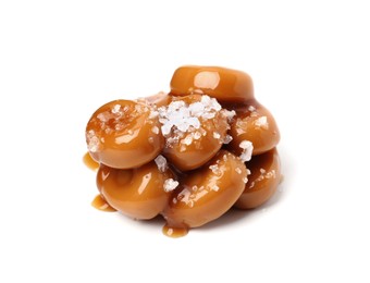 Photo of Tasty sweet candies, salt and caramel sauce isolated on white