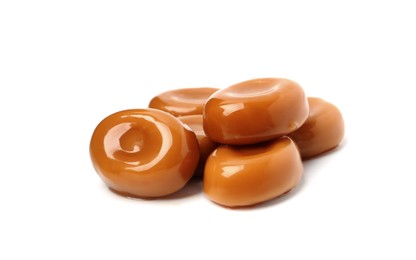 Photo of Tasty sweet caramel candies isolated on white