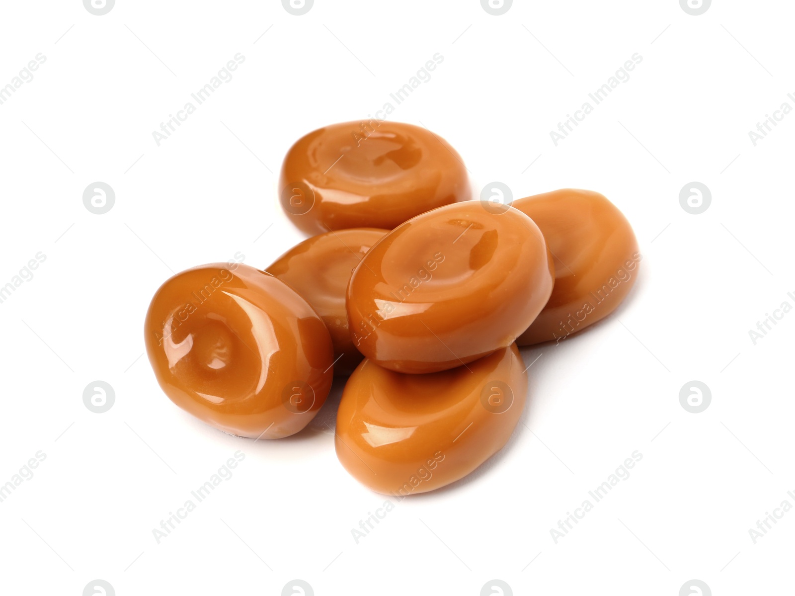 Tasty sweet caramel candies isolated on white Photo of Tasty sweet caramel candies isolated on white