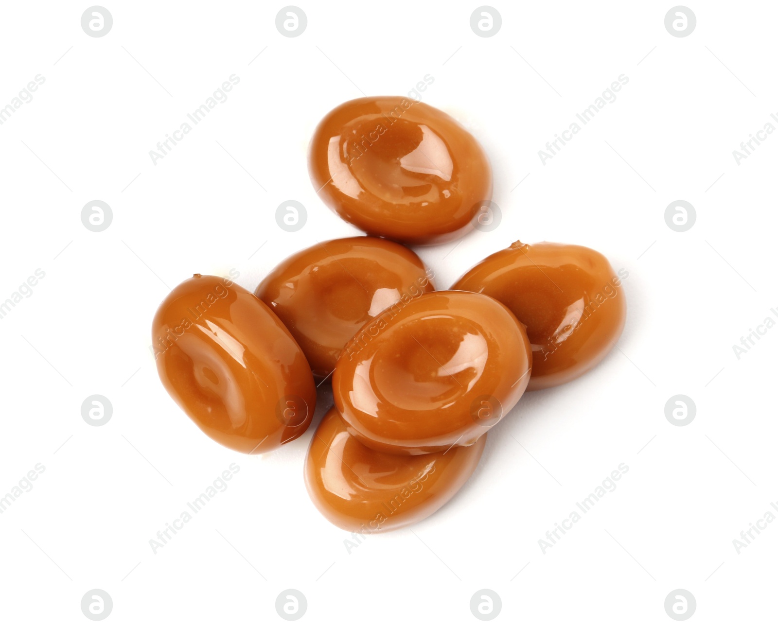 Tasty sweet caramel candies isolated on white, top view Photo of Tasty sweet caramel candies isolated on white, top view