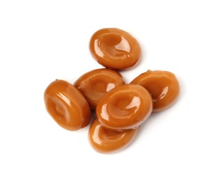 Photo of Tasty sweet caramel candies isolated on white, top view