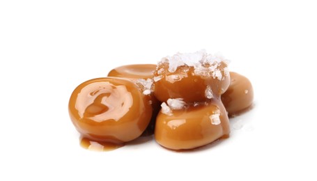 Photo of Tasty sweet candies, salt and caramel sauce isolated on white
