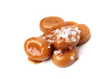 Photo of Tasty sweet candies, salt and caramel sauce isolated on white