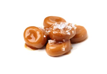 Photo of Tasty sweet candies, salt and caramel sauce isolated on white