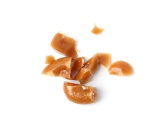 Photo of Tasty sweet caramel candies isolated on white, top view