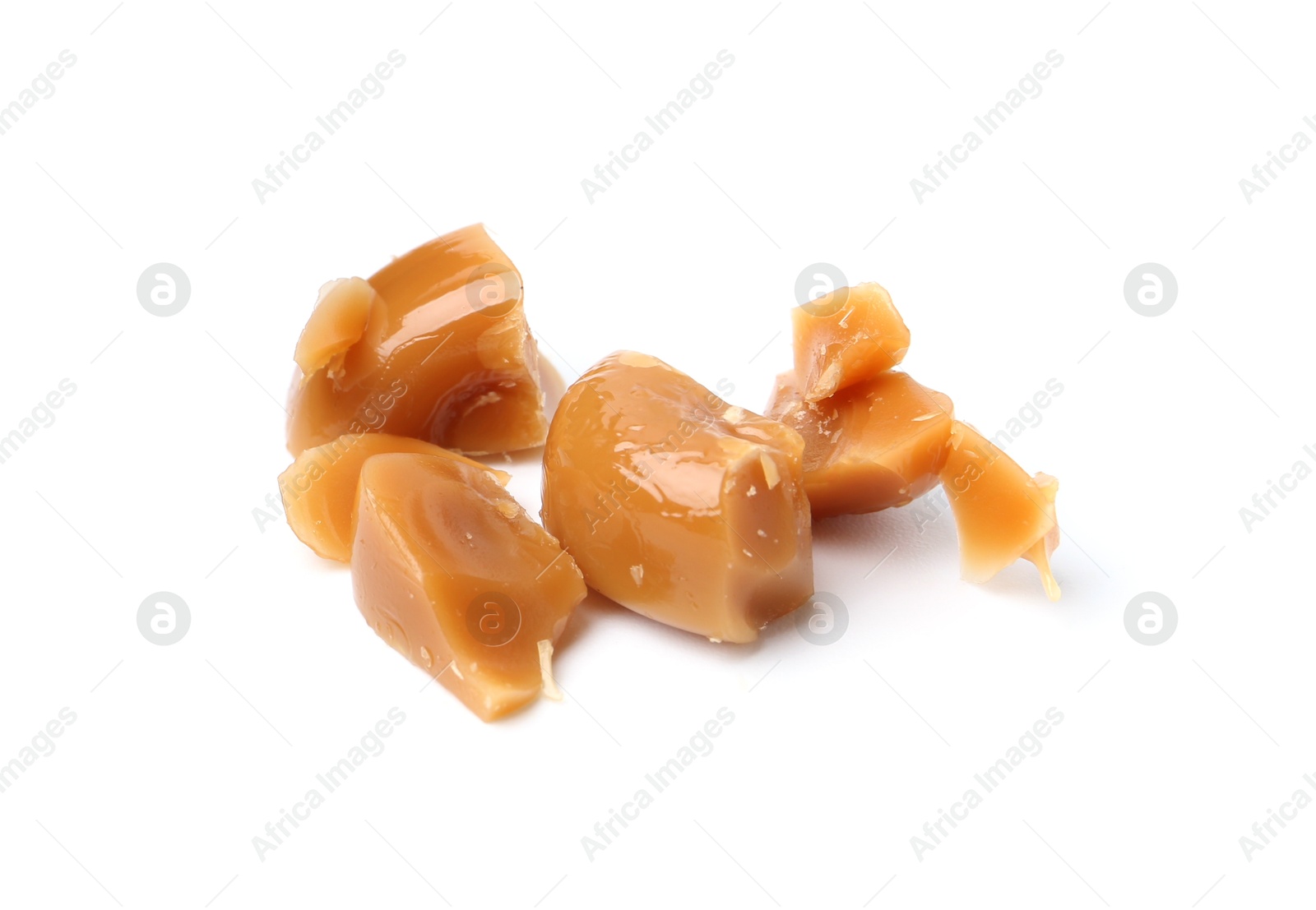 Tasty sweet caramel candies isolated on white Photo of Tasty sweet caramel candies isolated on white