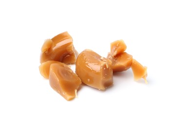 Photo of Tasty sweet caramel candies isolated on white