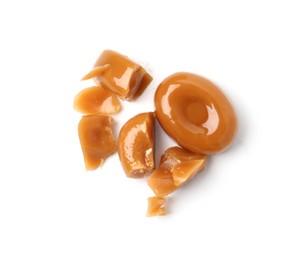 Photo of Tasty sweet caramel candies isolated on white, top view