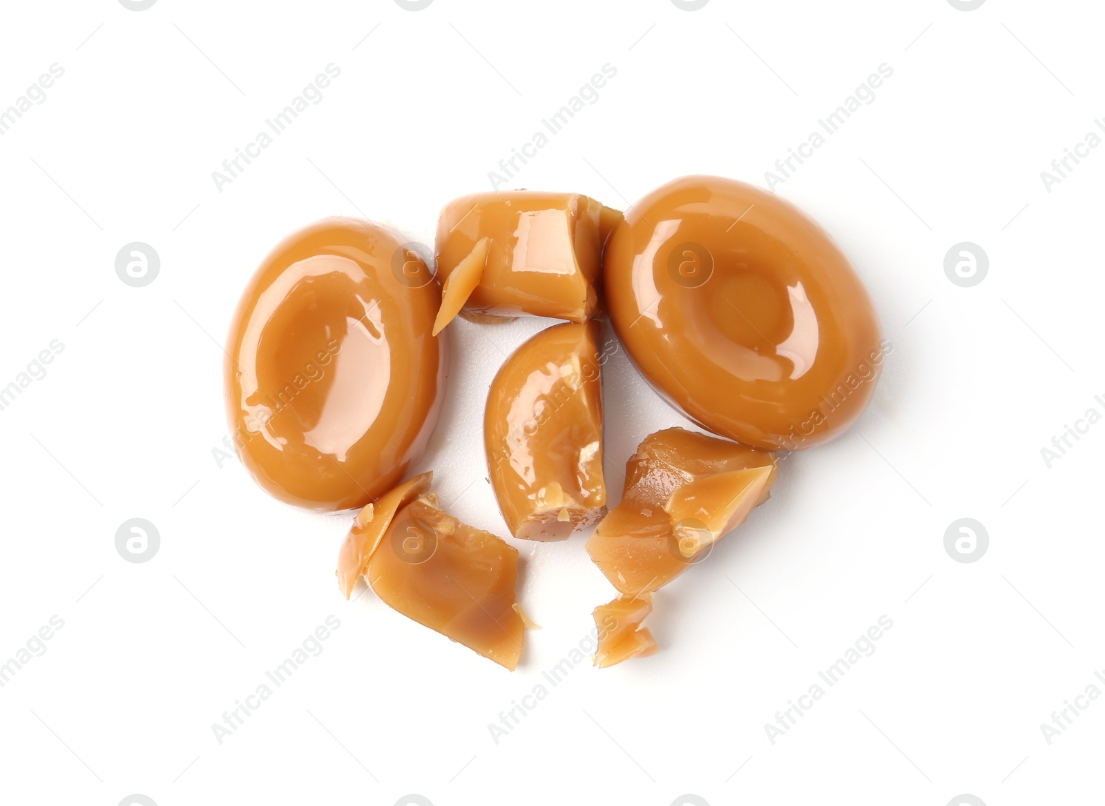 Tasty sweet caramel candies isolated on white, top view Photo of Tasty sweet caramel candies isolated on white, top view