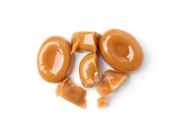 Photo of Tasty sweet caramel candies isolated on white, top view