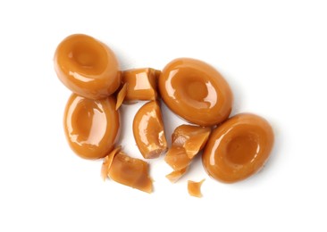 Photo of Tasty sweet caramel candies isolated on white, top view