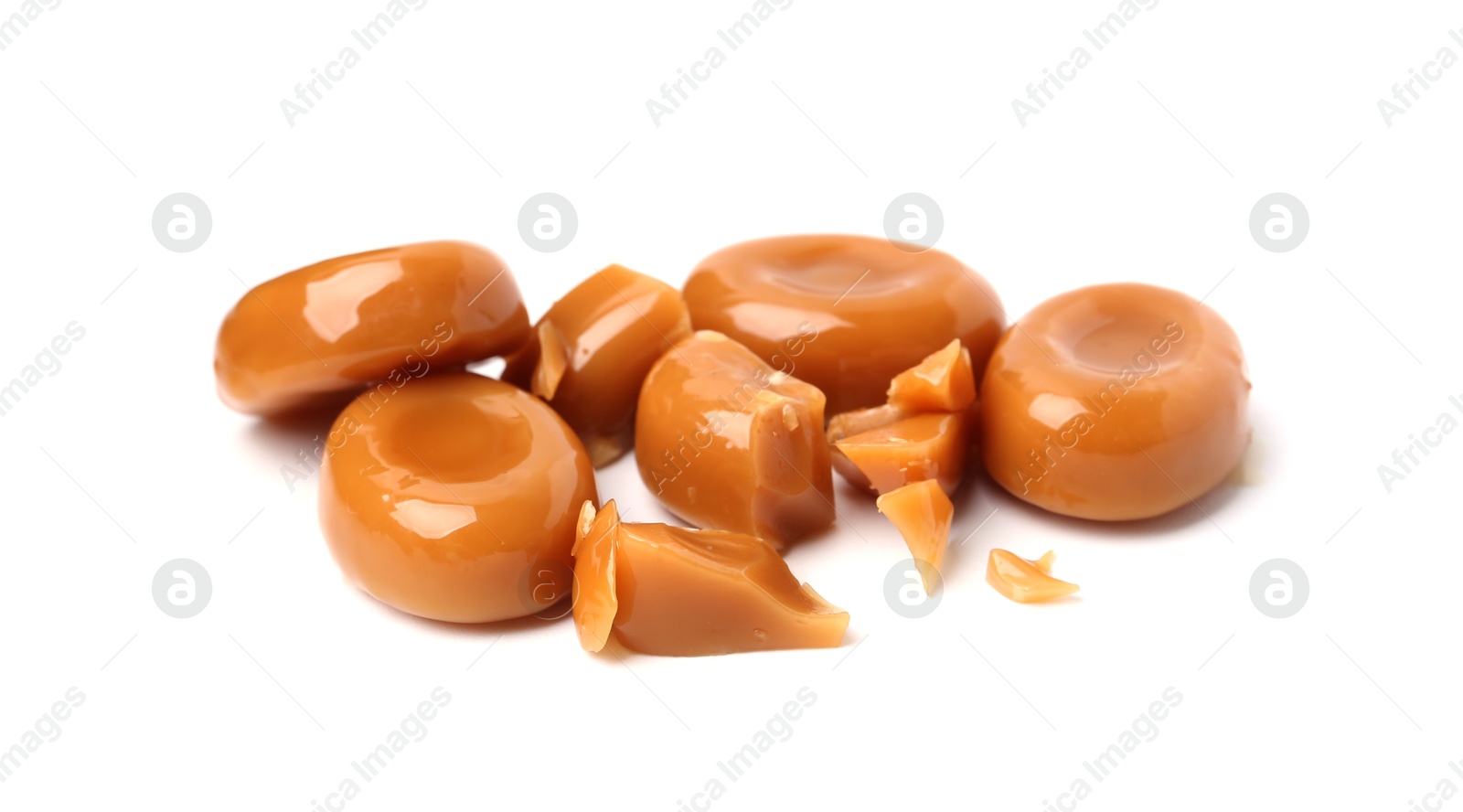 Tasty sweet caramel candies isolated on white Photo of Tasty sweet caramel candies isolated on white