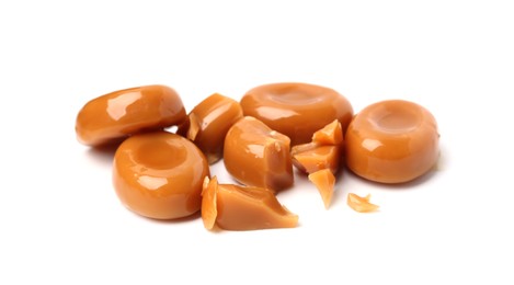 Photo of Tasty sweet caramel candies isolated on white
