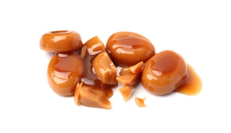 Photo of Tasty sweet candies and caramel sauce isolated on white