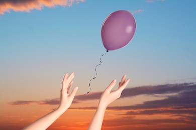Image of Woman letting balloon out of her hands into sky, closeup. Freedom concept