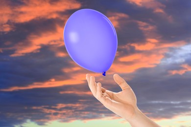 Image of Man letting balloon out of his hand into sky, closeup. Freedom concept