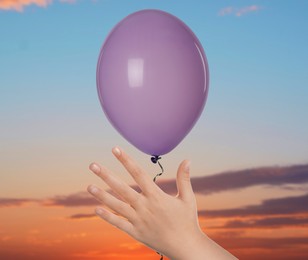 Image of Child letting balloon out of hand into sky, closeup. Freedom concept