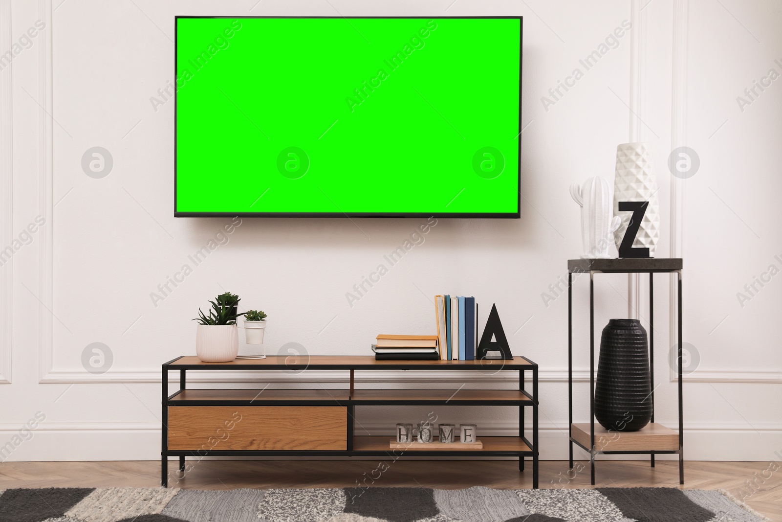 TV set with green screen on white wall in room. Chroma key compositing Image of TV set with green screen on white wall in room. Chroma key compositing