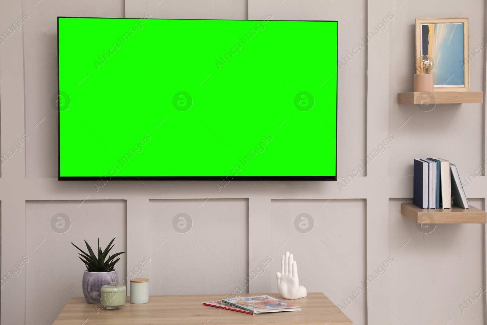 TV set with green screen on white wall in room. Chroma key compositing Image of TV set with green screen on white wall in room. Chroma key compositing