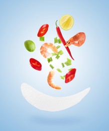Image of Rice paper and different ingredients falling on light blue gradient background